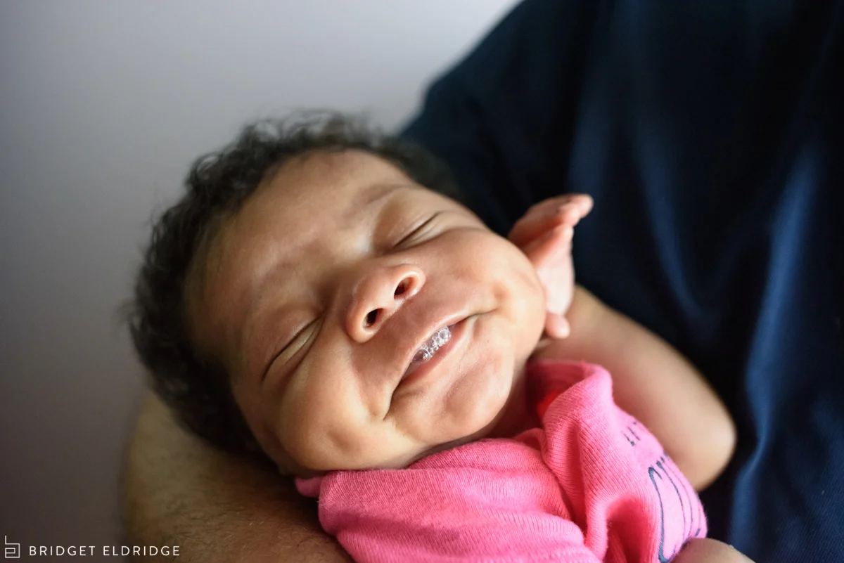 newborn blows bubbles