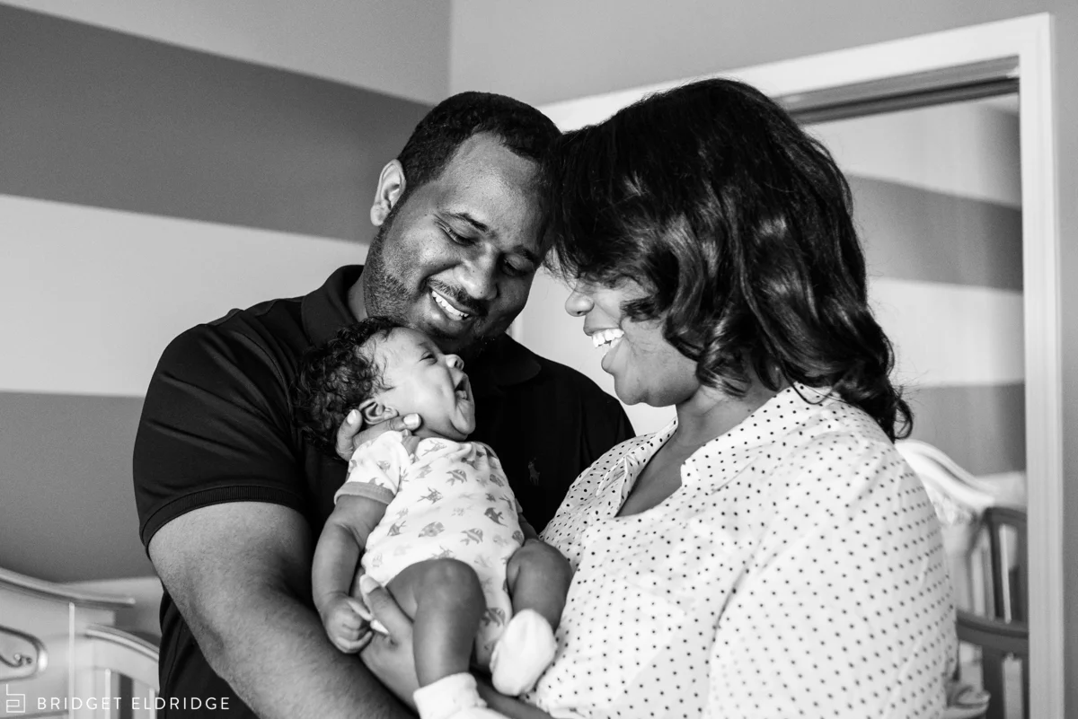 newborn smiles at her parents