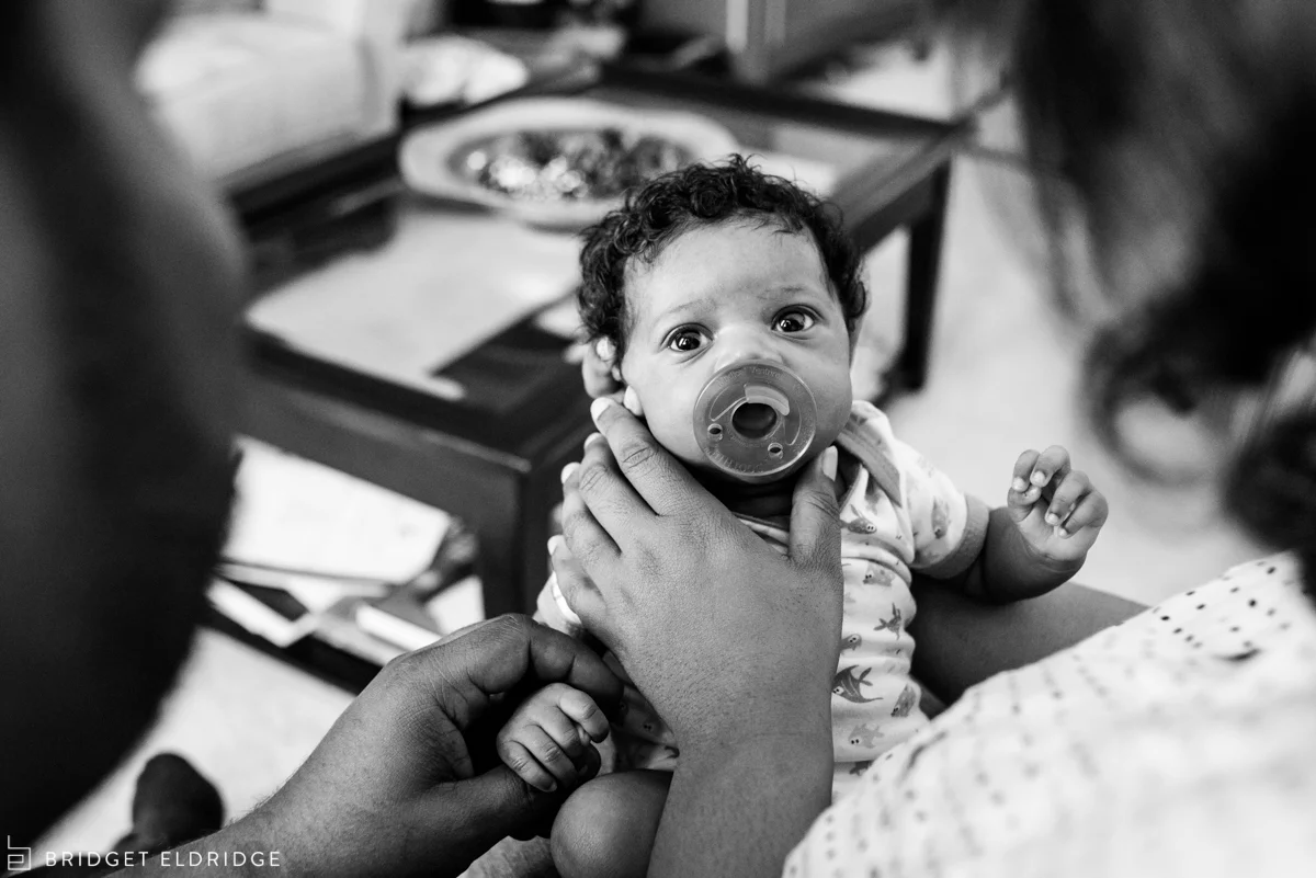 newborn sucks on a pacifer
