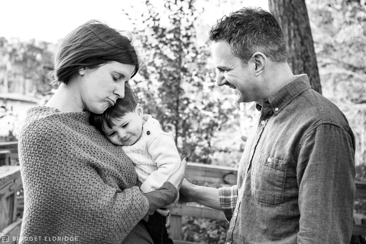 mom comforts son as dad looks on
