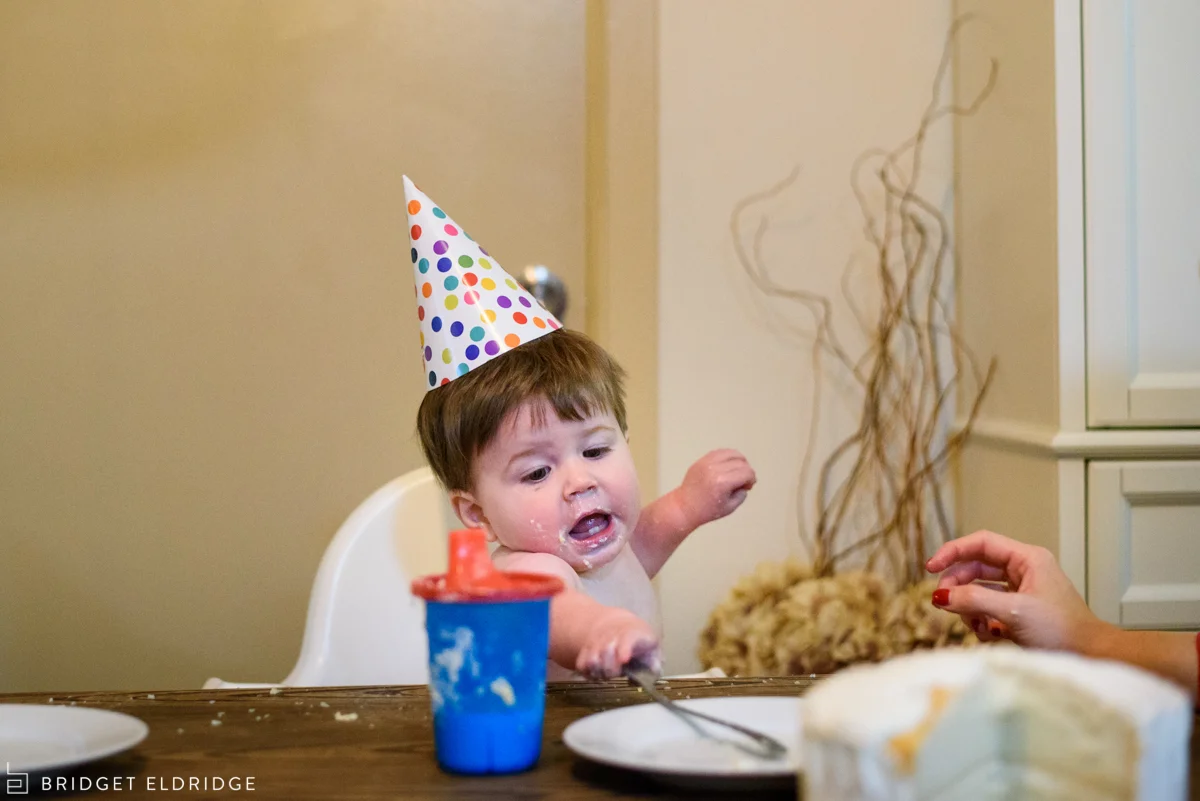 little boy bangs on a plate with his fork