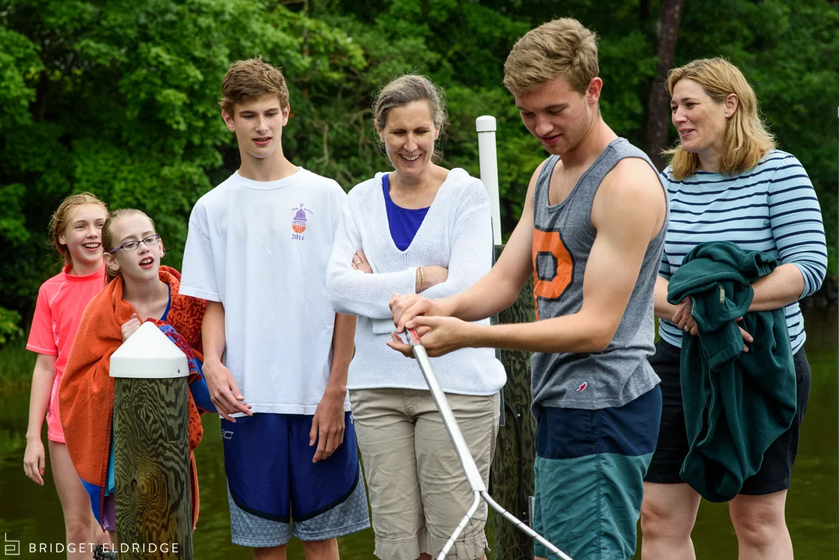 family watches as teenager catches jellyfish