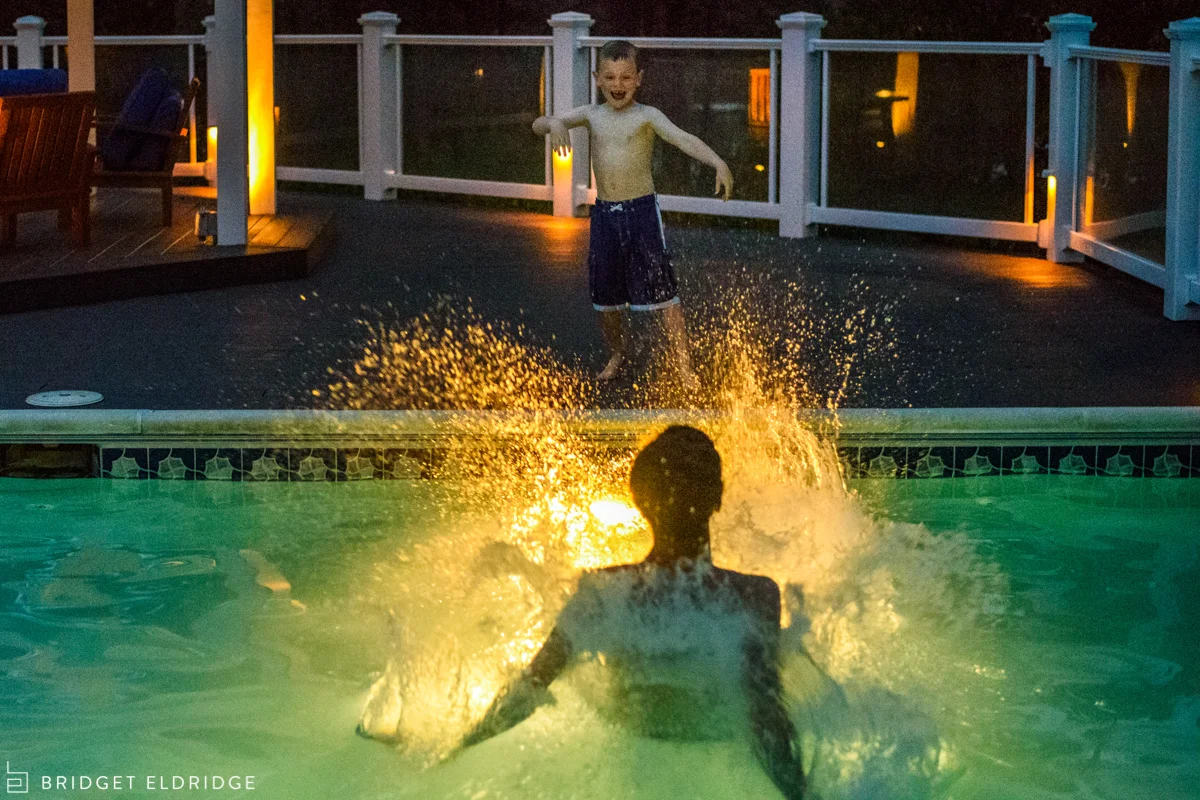 boy pushes his teeange cousin in the pool