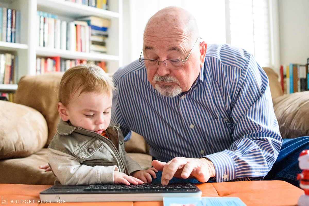 grandfather and grandson type on a keyboard