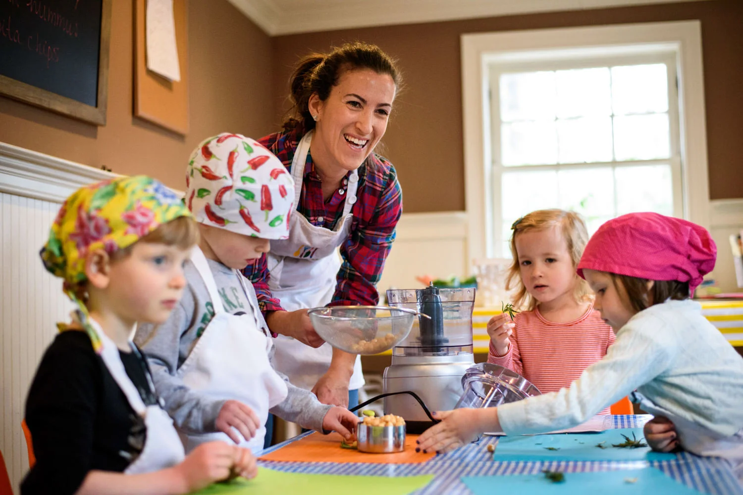 Chef Mari teaches kids about making hummus at Together We Cook