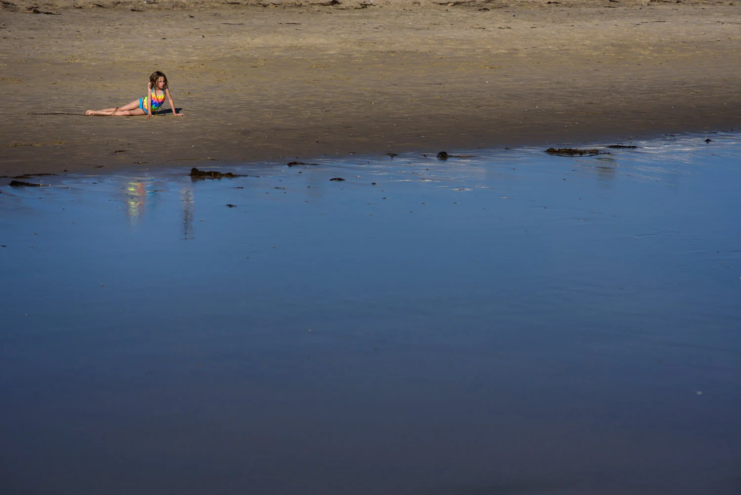 girl hangs out on the beach in orange county