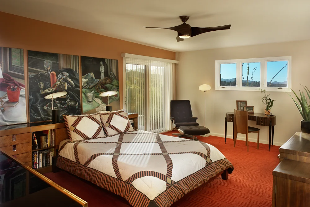 Standing in the newly relocated doorway, the eye is drawn to the exterior mountain views, outside the new windows and sliding glass door.