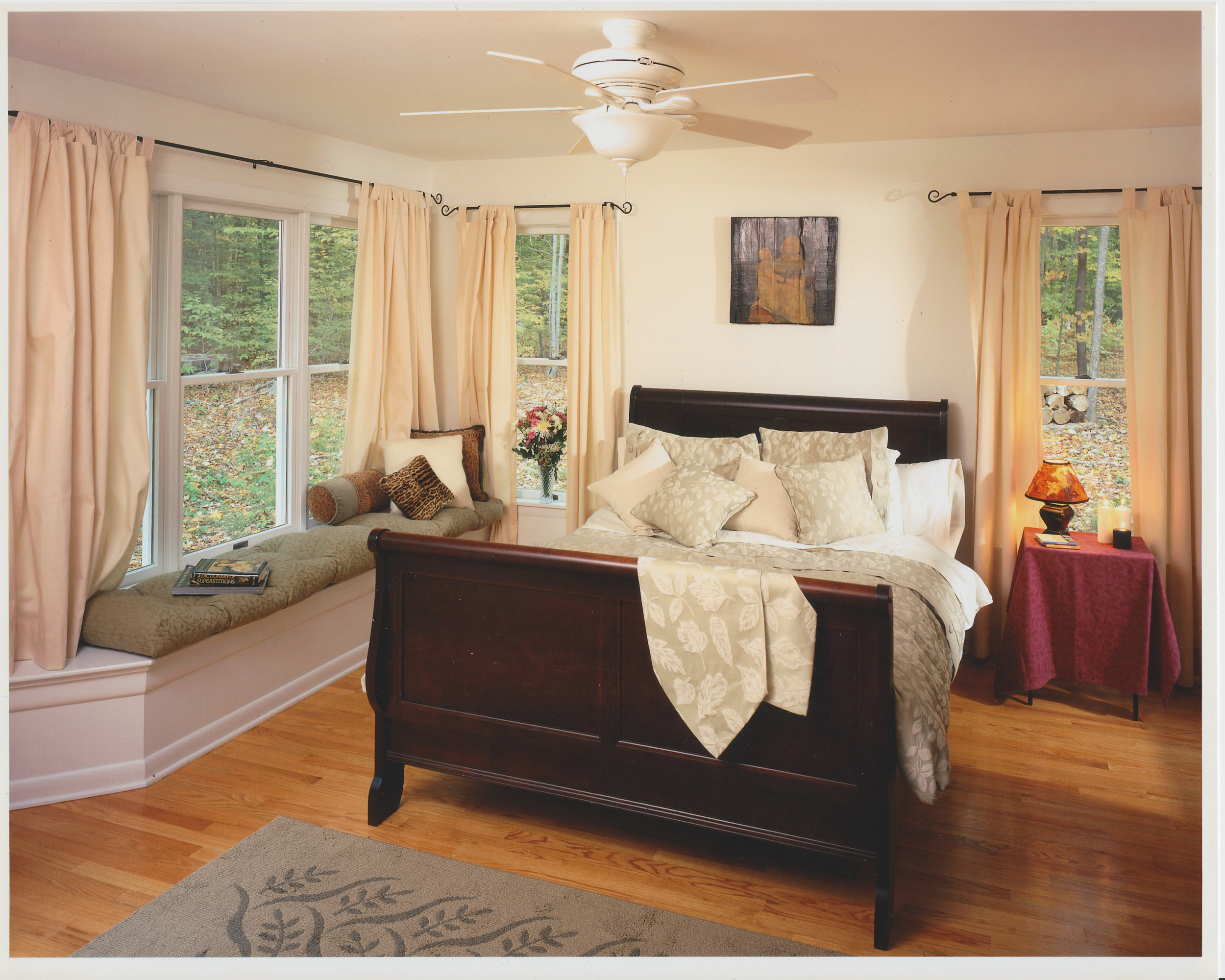  View of Master Bedroom with a built-in window seat that doubles as storage space for the bed linens.   