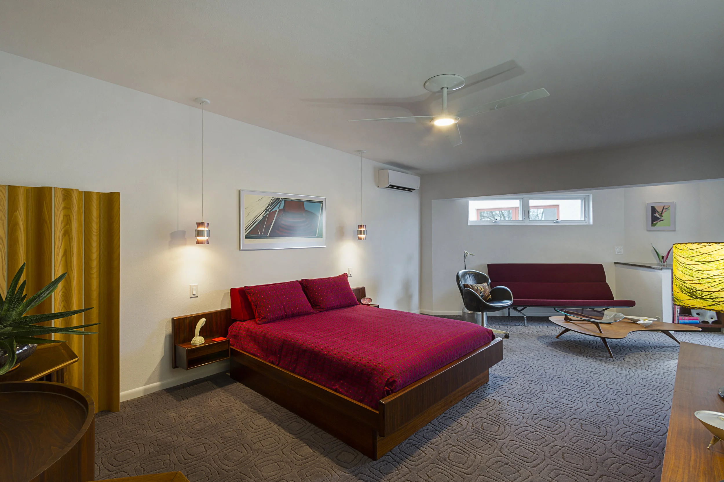The bedroom was created in the footprint of the former garage. An angled sitting area was added to open the space to the view beyond.