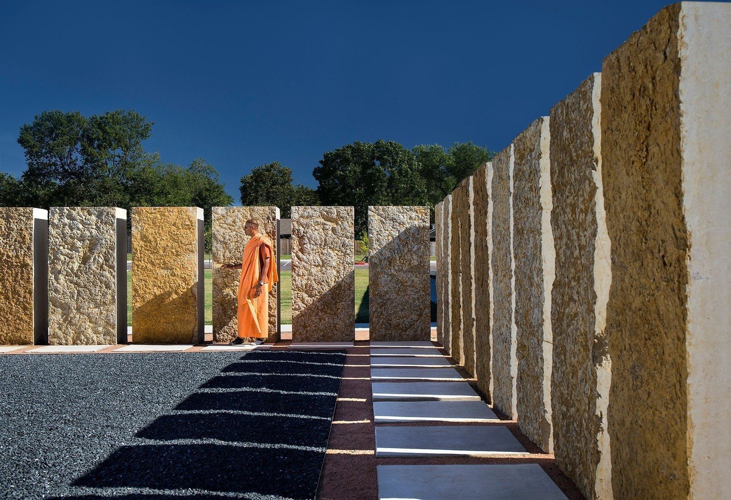 Surrounding the temple, a perimeter of rough-cut stones obscures the view beyond when worshippers are seated inside, focusing their attention back inward and encouraging meditation and introspection. #ChinmayaMissionAustin #MiroRiveraArchitects #MRAP