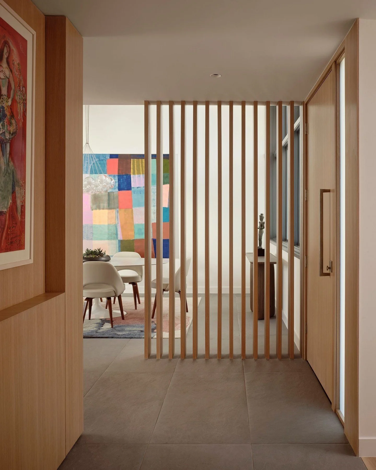 Inside, a screen of thin vertical oak members separates the foyer from the dining area. The sidelight and dining room windows feature &ldquo;switchable&rdquo; electrochromic privacy glass that can be activated to obscure views from the street. #Resid