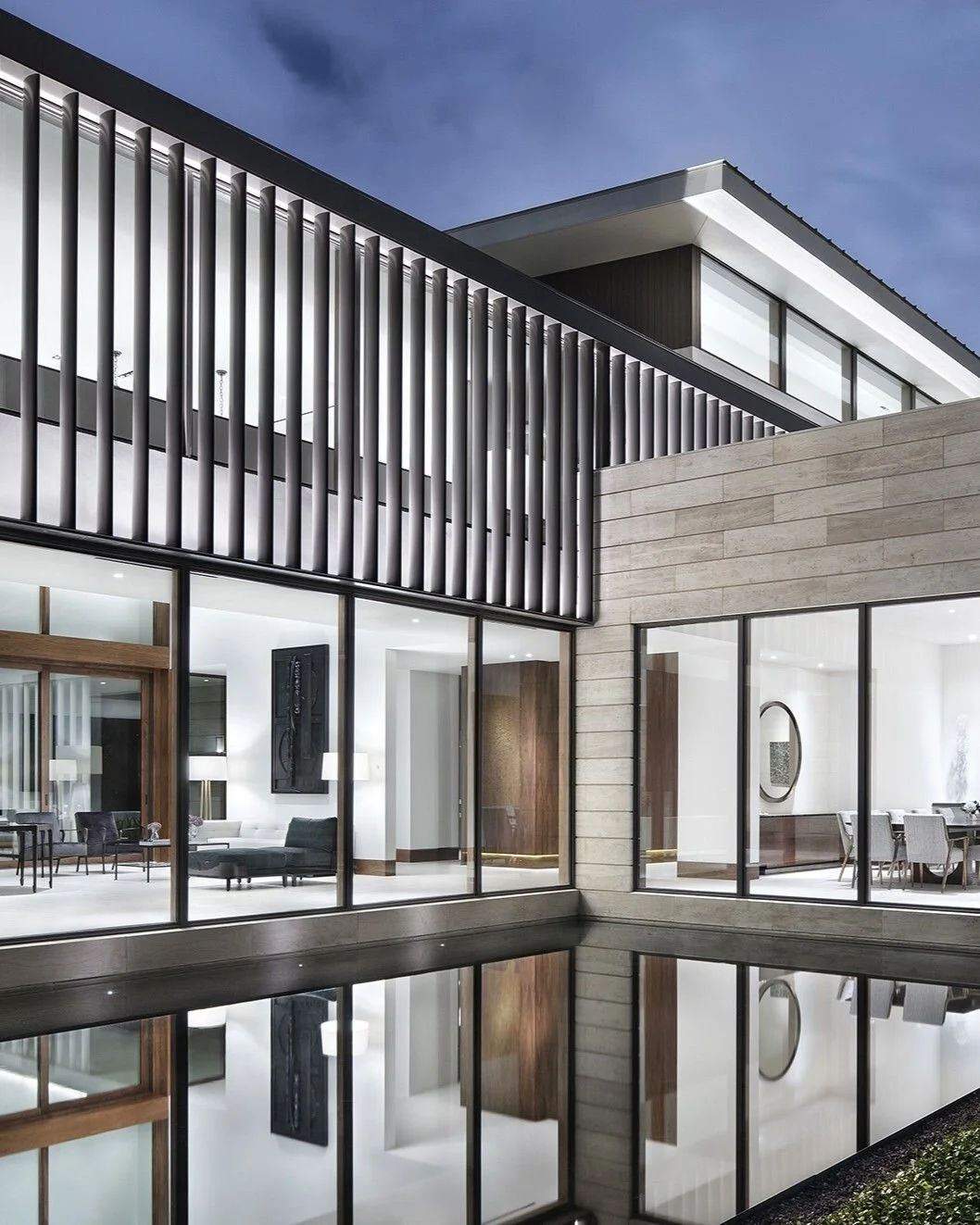 The stone-and-glass volume of the formal dining room appears to float within the still waters of the reflecting pool. #WestResidence #MiroRiveraArchitects #MRAProjectoftheWeek 🔨 Renaissance Builders 📷 Paul Finkel
