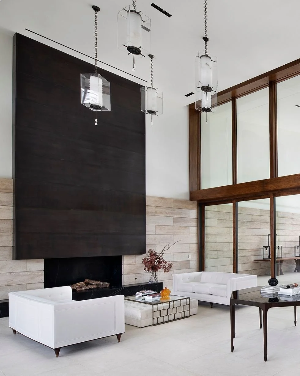 Flooded with natural light that has been diffused by deep overhangs, the double-height living room features two walls of glass and a fireplace made from oil-rubbed bronze. #WestResidence #MiroRiveraArchitects #MRAProjectoftheWeek 🔨 Renaissance Build