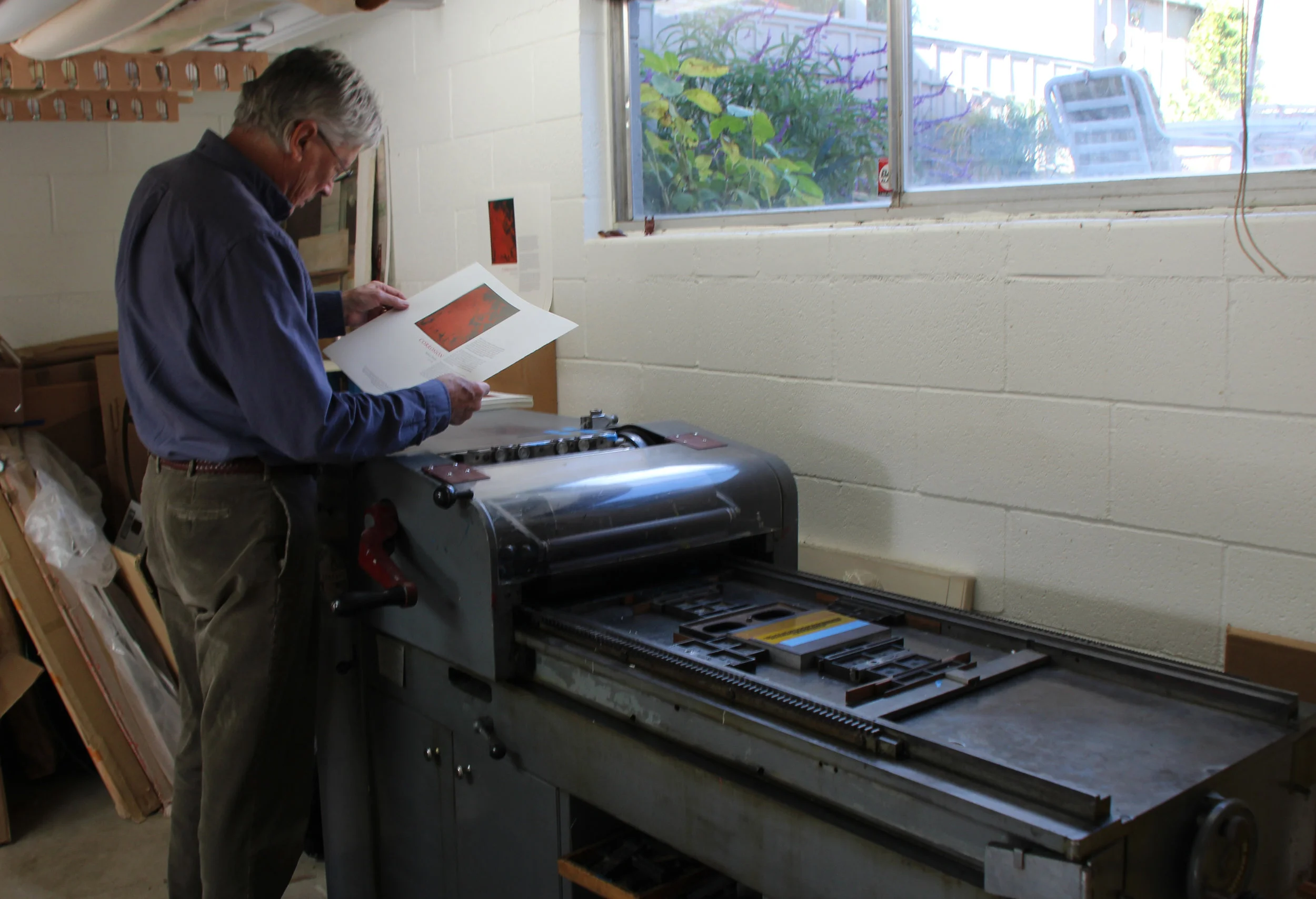 Richard Wagener examining a copy of “Corrosion” in Petaluma.