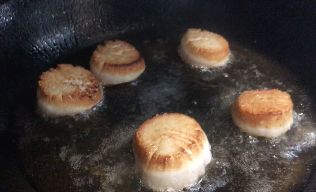 Searing the scallops.