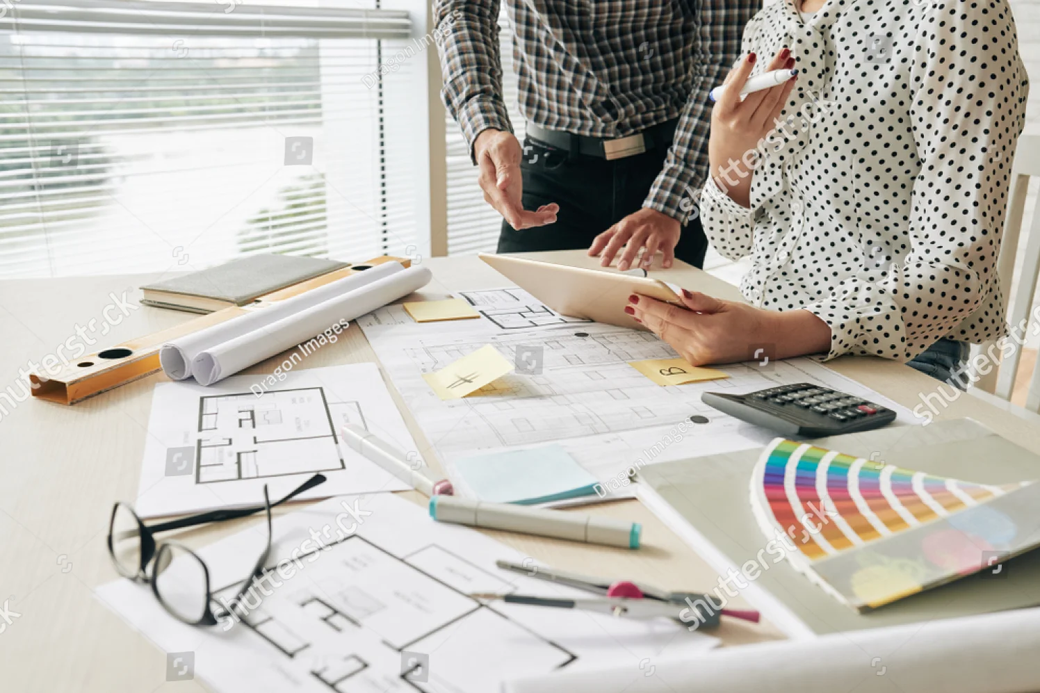 stock-photo-cropped-image-of-interior-designers-discussing-ideas-for-new-project-1035247144.jpg
