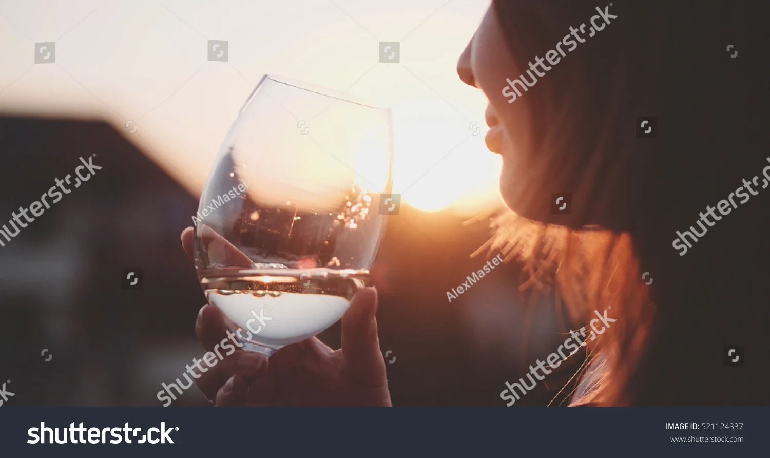stock-photo-woman-drinking-cooled-white-wine-from-a-glass-at-the-balcony-during-sunset-beautiful-female-521124337.jpg