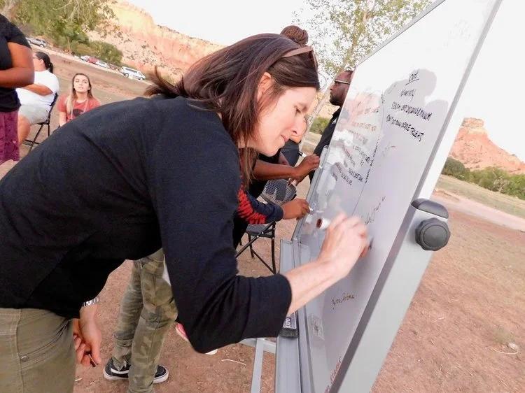 Kristen Ragain of REI signs the Fresh Tracks Community Contract on the first day of the regional training in Abiquiú, New Mexico.