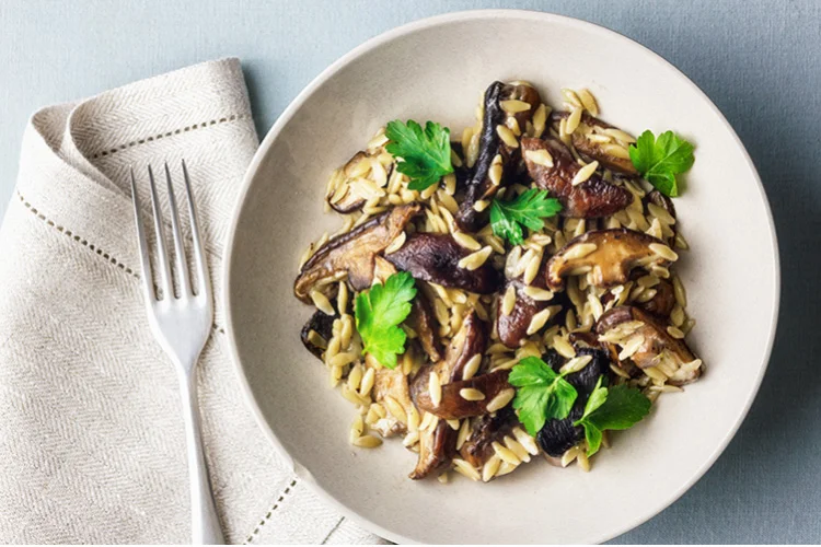 Portobello mushrooms with orzo sauce a fork and a pencil