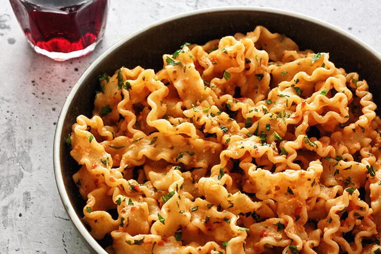 Mafaldine with Trapanese pesto a fork and a pencil