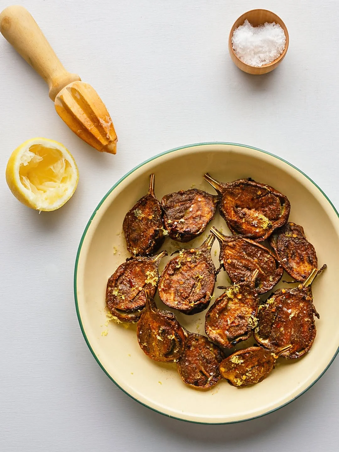 Spiced baby eggplants 

I like these golf-ball sized eggplants because you can roast them very quickly and they hold their shape. I smoosh them around in cumin, coriander, cinnamon and red chilli flakes and, when they're done, shower them with lemon 