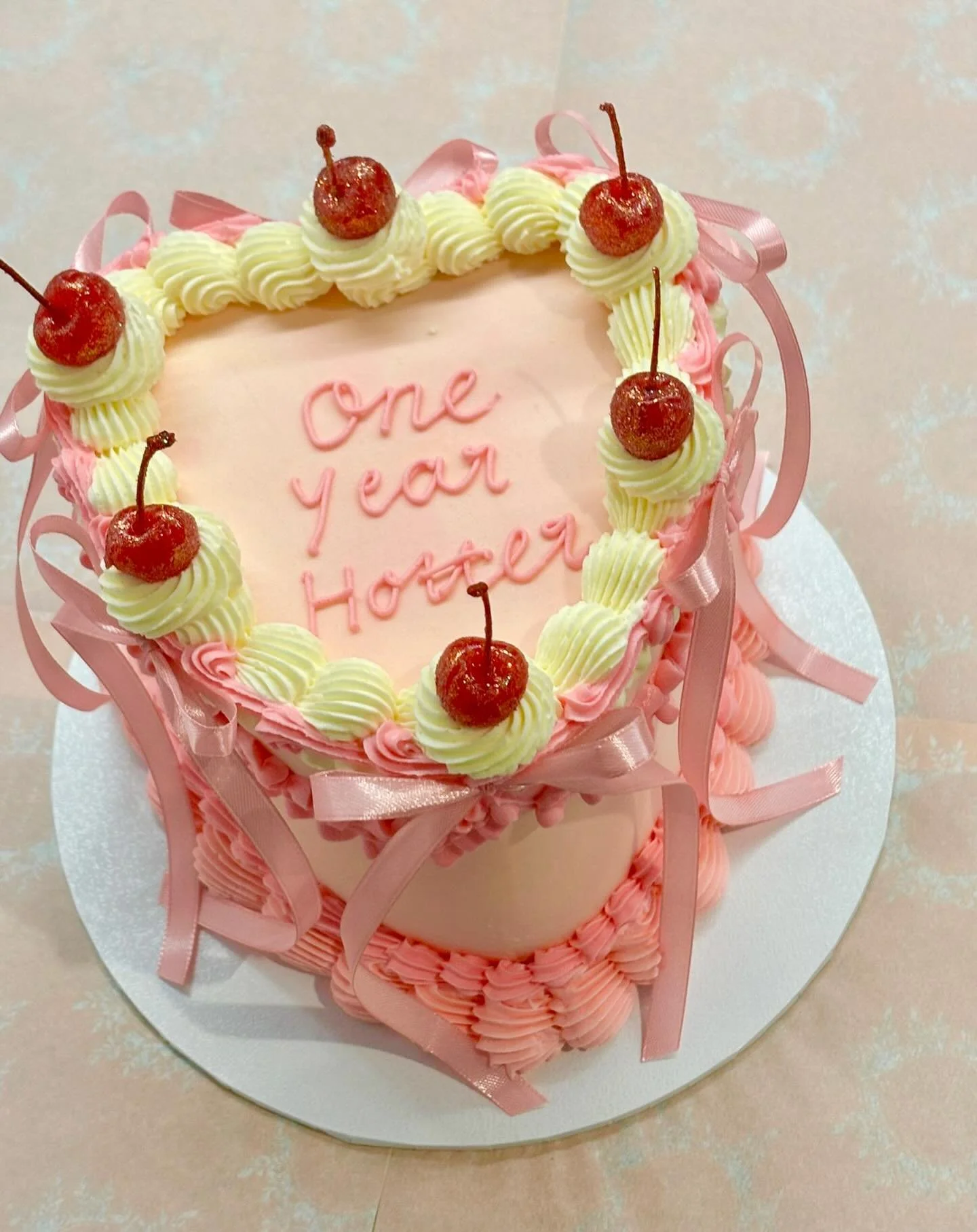 One year hotter 💗🍒

Vintage heart cake dreams with soft blush tones, piped details, satin ribbons and those glossy cherries on top&hellip; she&rsquo;s a moment ✨

Perfect for birthdays, milestones or just because 💕
Custom colours &amp; wording alw