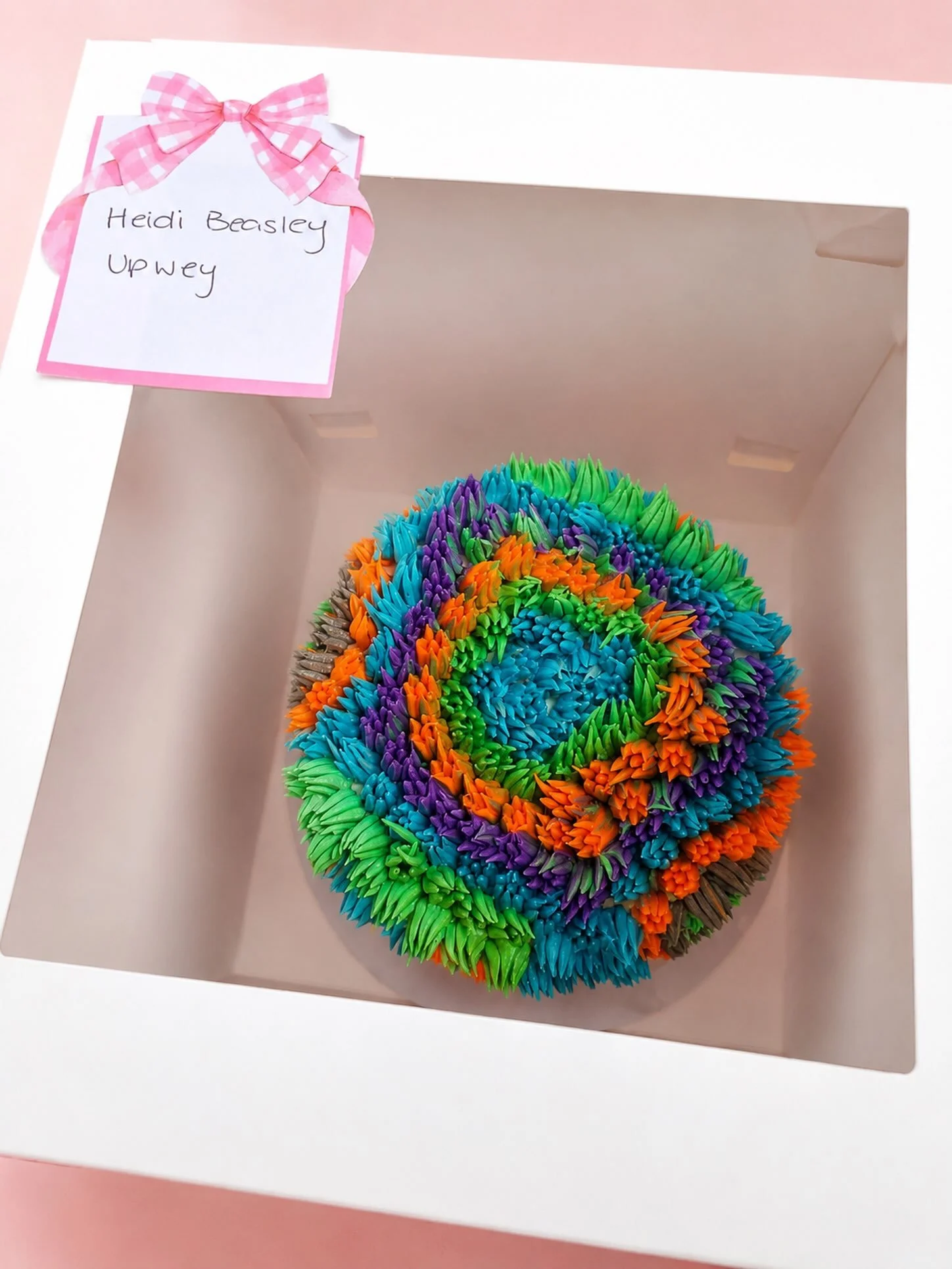 A little wild, a little colourful, and completely custom 🌈✨

This very custom shaggy cake heading out to its new home 💜🩵💚🧡

📸 Courier delivery snap! We photograph every cake on arrival, so we know it&rsquo;s been delivered safely and looking ju