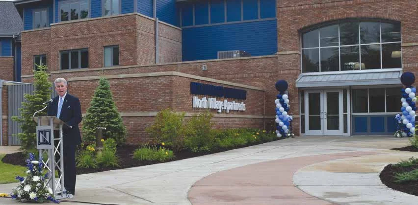 President Keith Pretty speaks at the June 28 ceremony unveiling the completed North Village Apartments building.