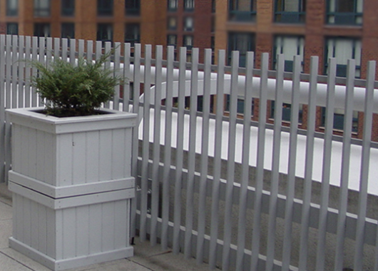 White fence with a plant