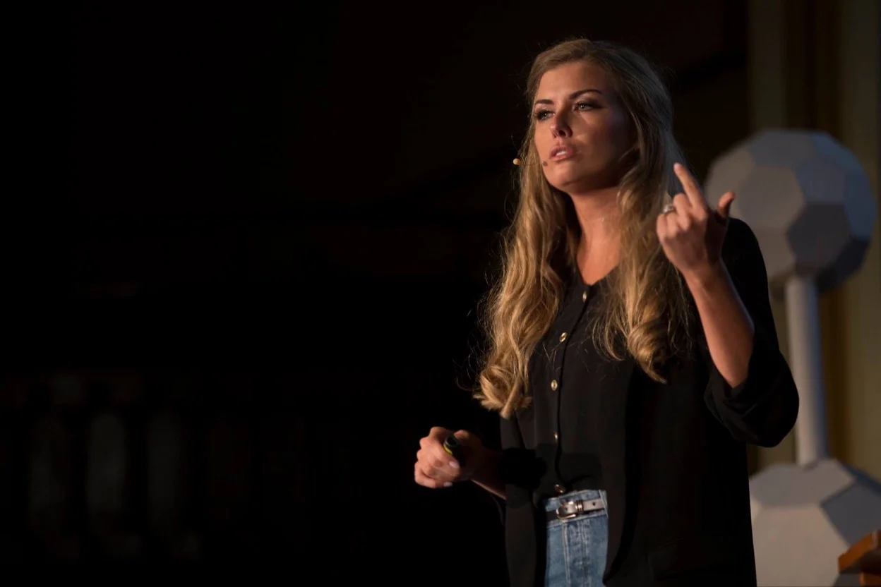 Ayla Abiad on stage presenting Build A Bridge Foundation at TEDxBuffalo in February 2018. Courtesy AIA Columns.