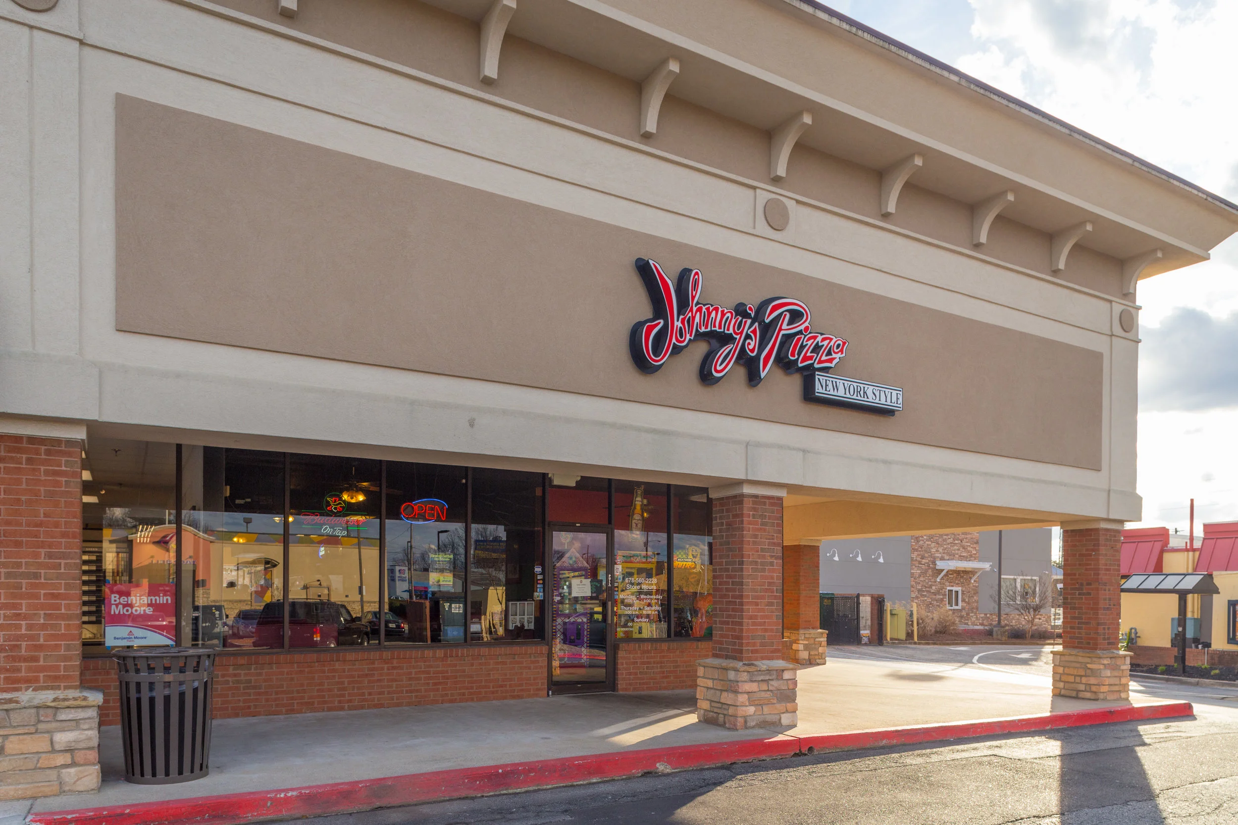 The exterior storefront of Johnny's Pizza at Parkaire Landing