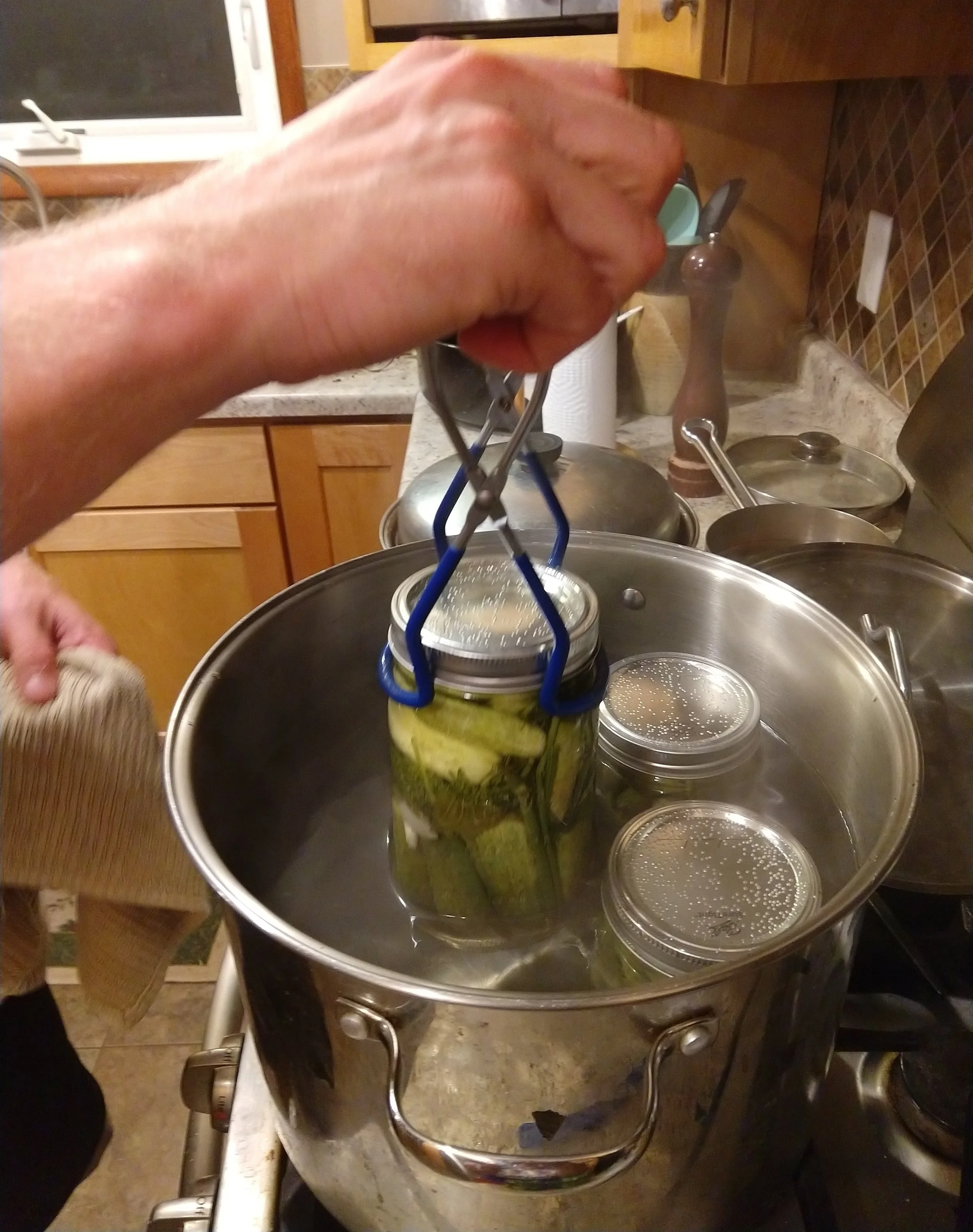 We carefully take each jar out of the hot water bath.