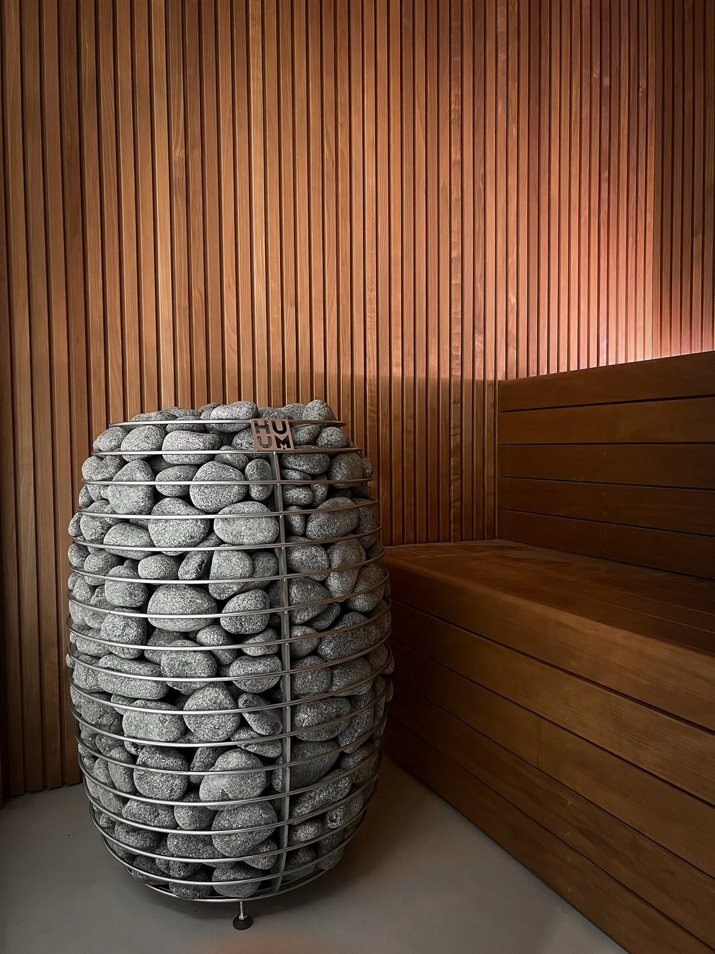 Custom sauna. Thermo treated alder, microcement, bronze, reeded glass.