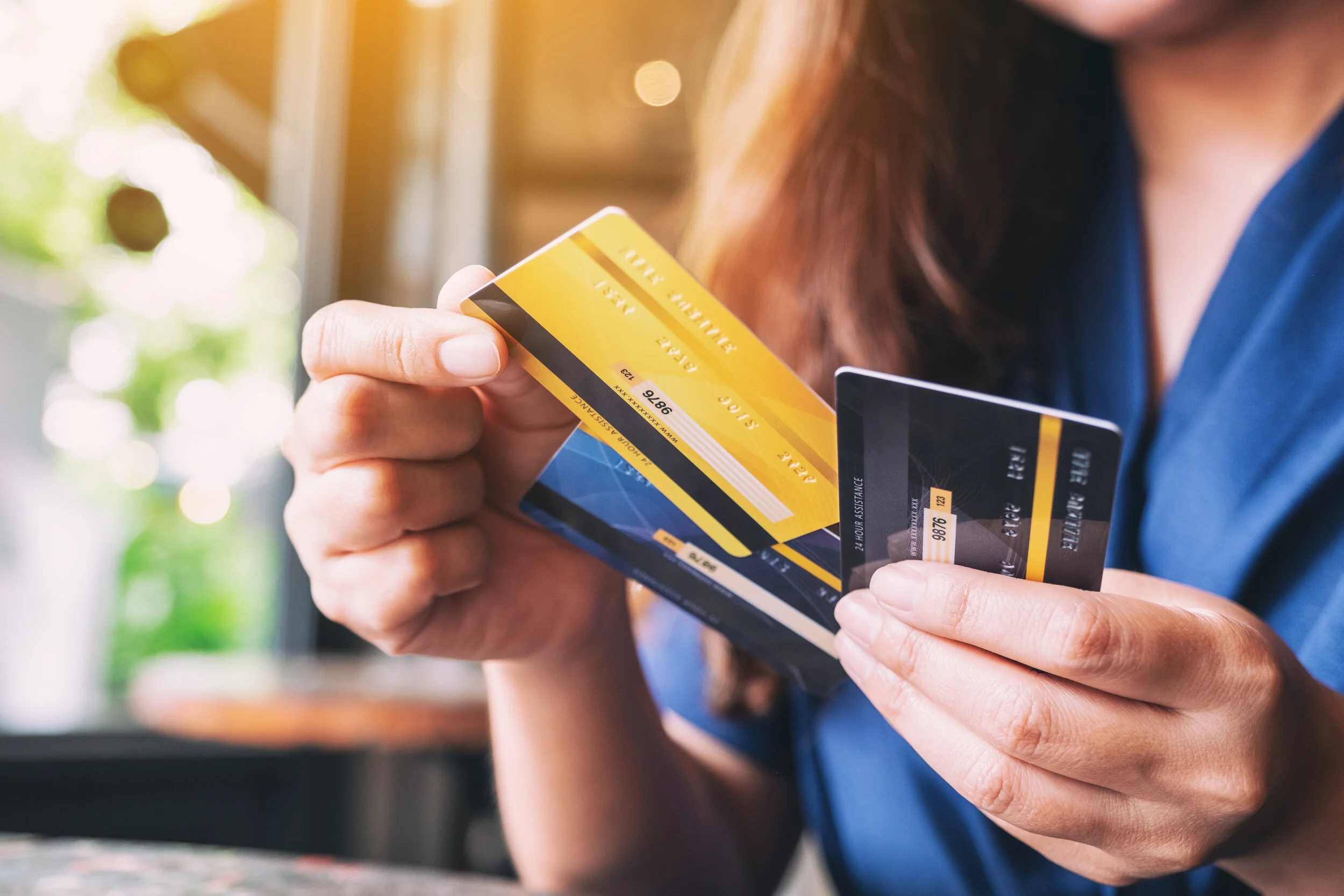 Closeup image of a woman holding and choosing credit card to use.jpg