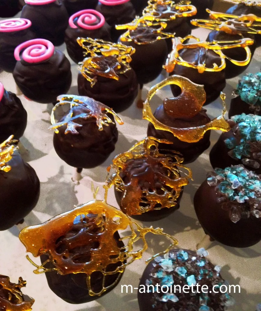 Chocolate coated and sugar decorated cheesecake bits-on-a-stick