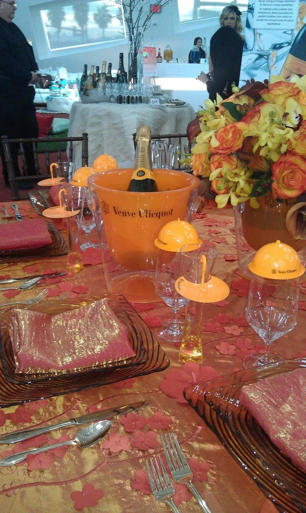 orange table setting with veuve clicquot