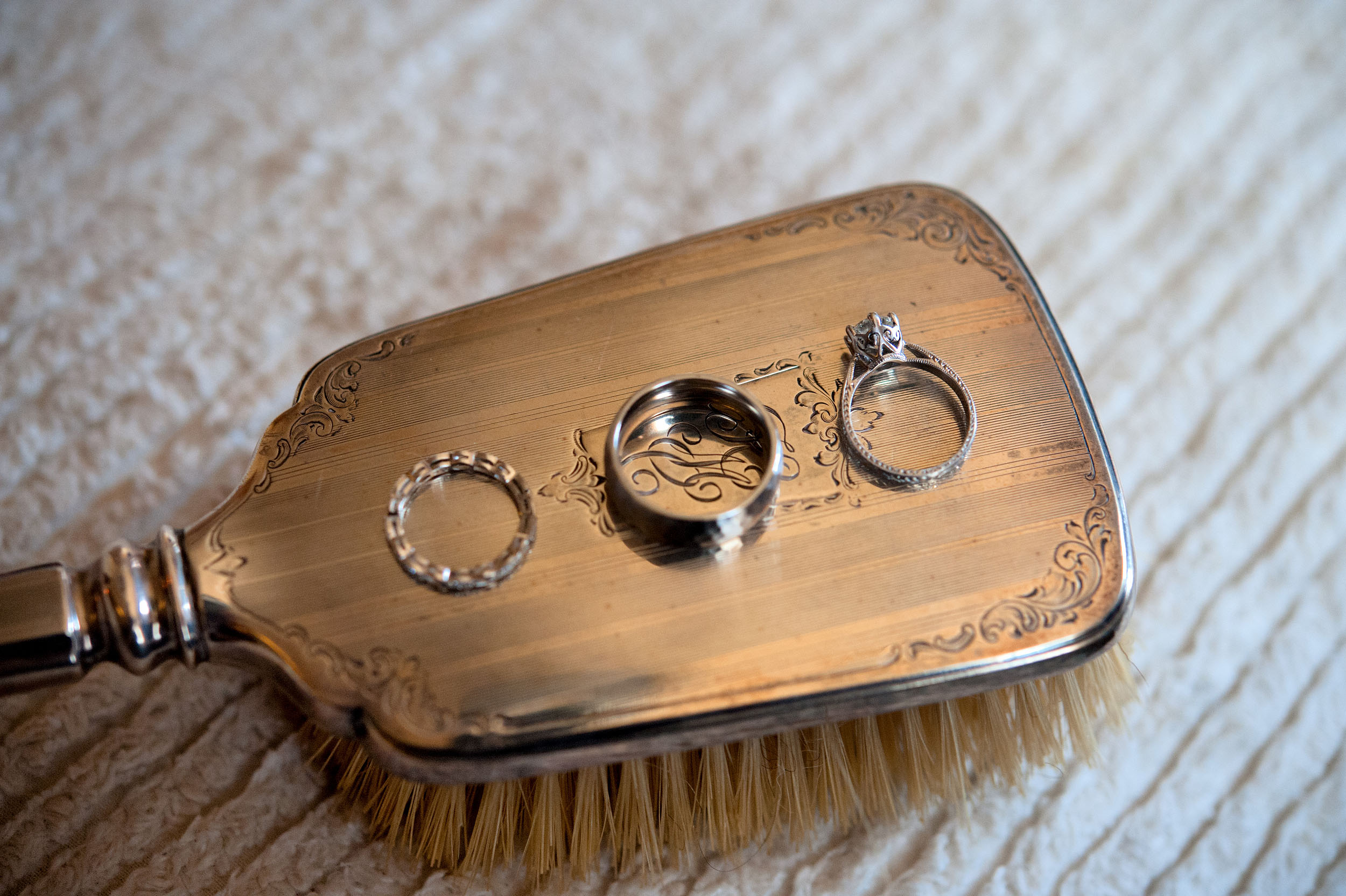 Bride's and Groom's rings on a silver hairbrush at the Oviatt Penthouse in Downtown Los Angeles.