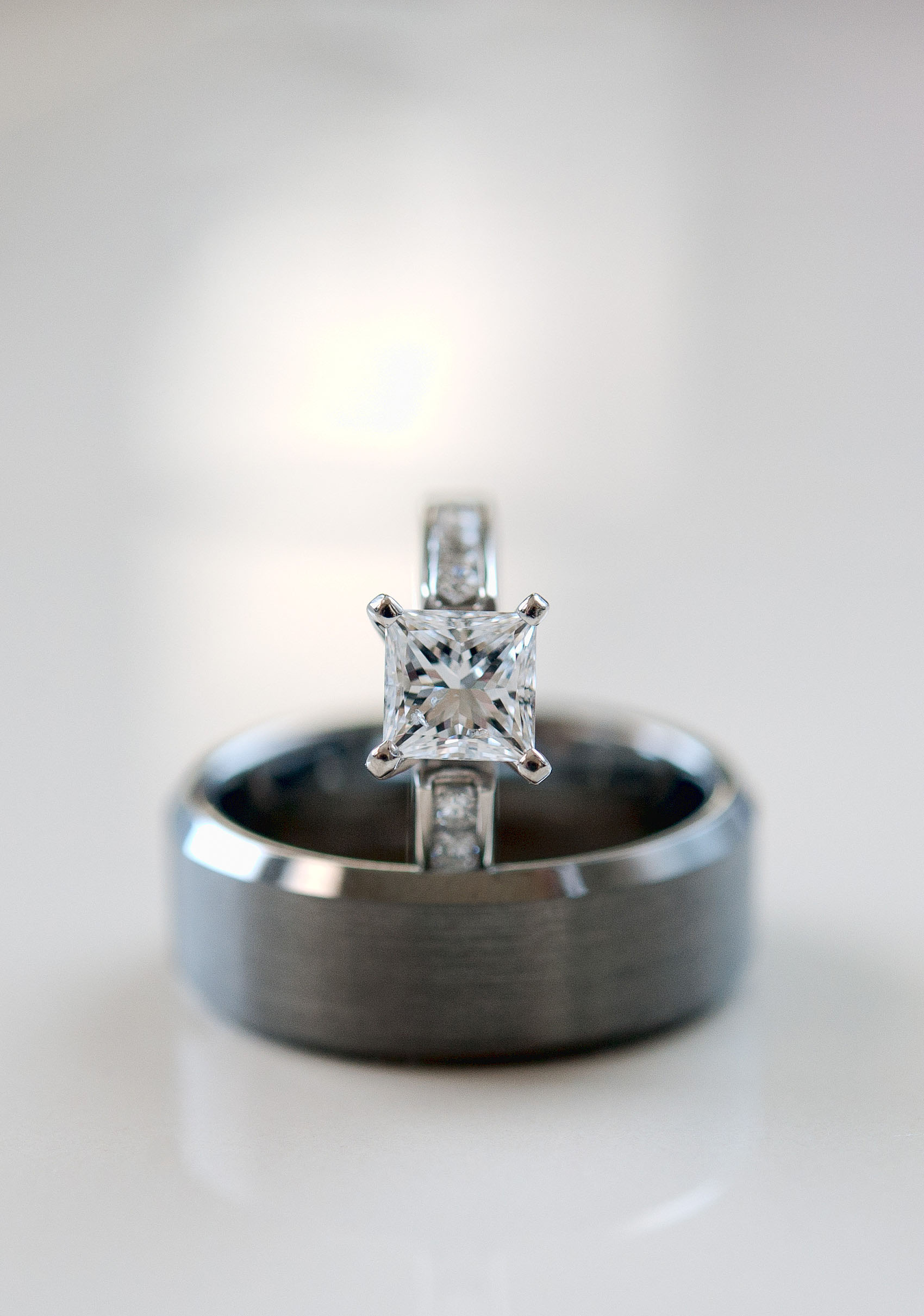 Bride's engagement ring standing in groom's wedding ring.