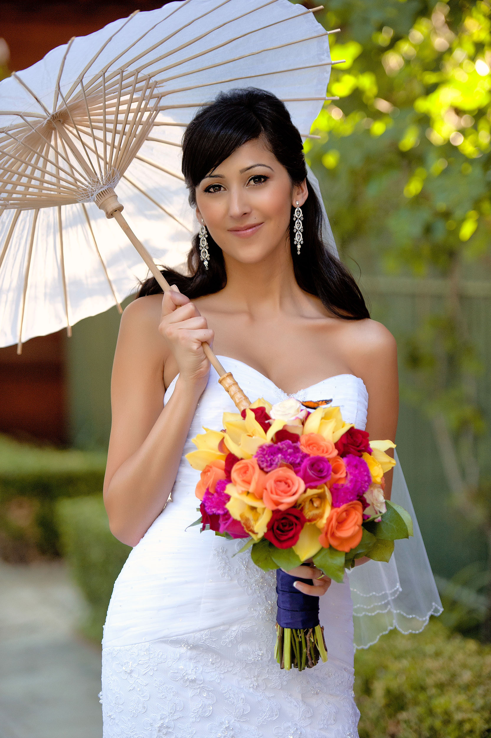 Bride with bouquet and parasol at A.K. Smiley Public Library in Redlands.