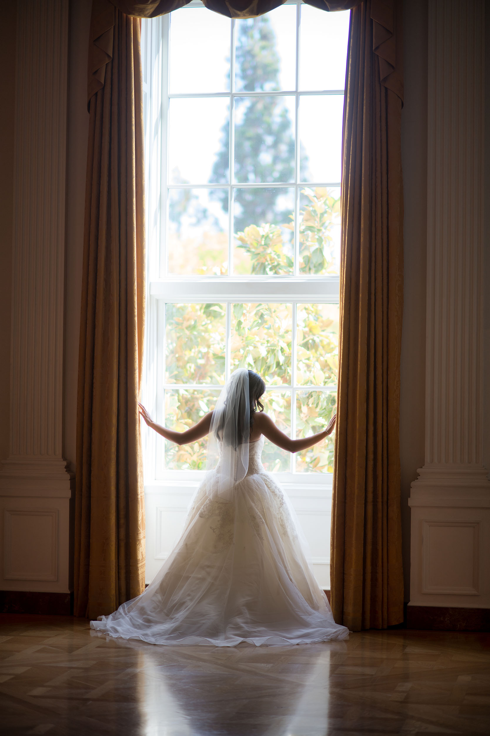 Bride backlit in window at the Richard Nixon Presidential Library & Museum in Yorba Linda.