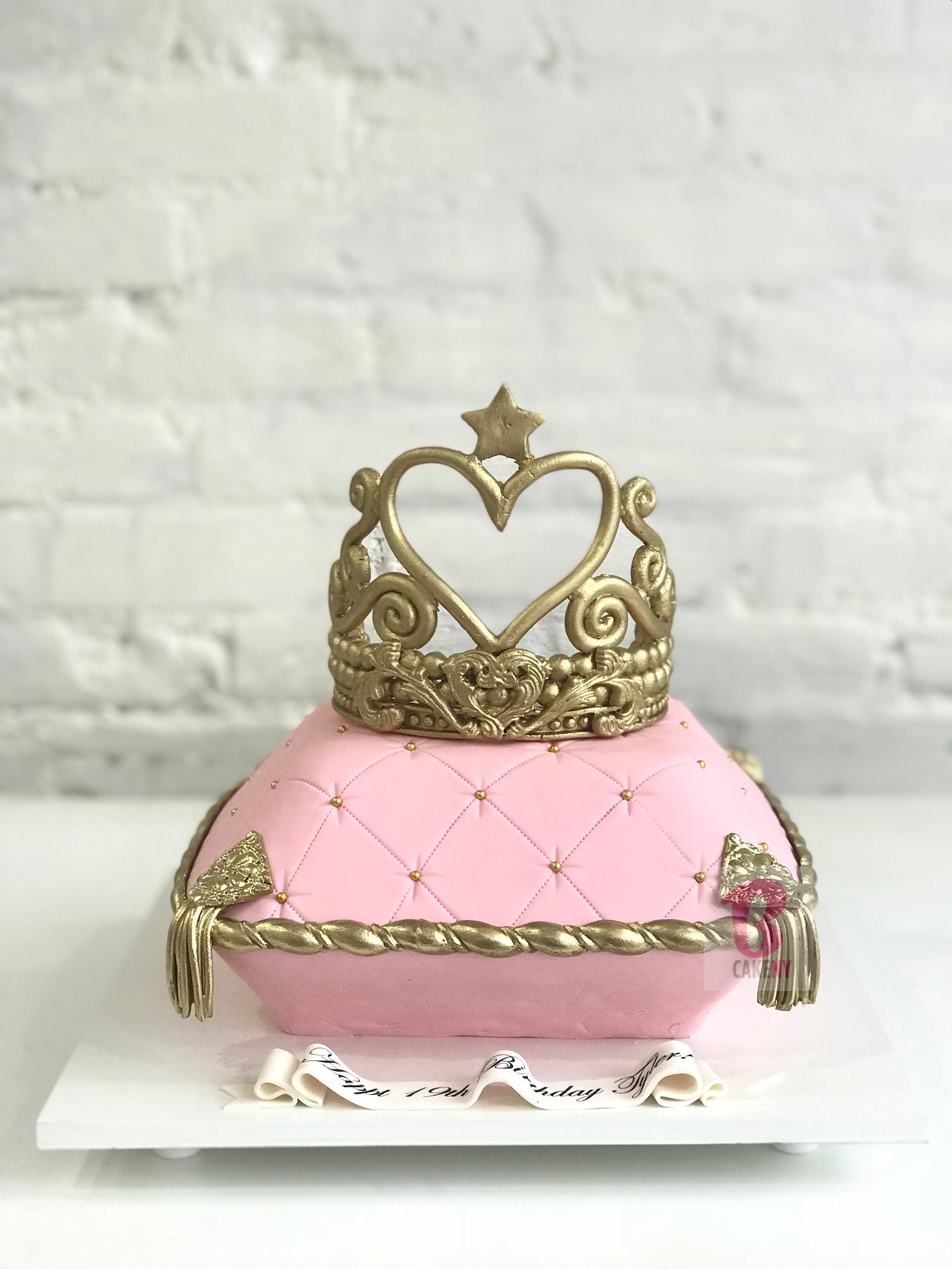 pink pillow shaped cake and sugar crown