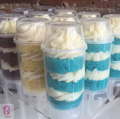 layers of cake and buttercream in clear push pop container 