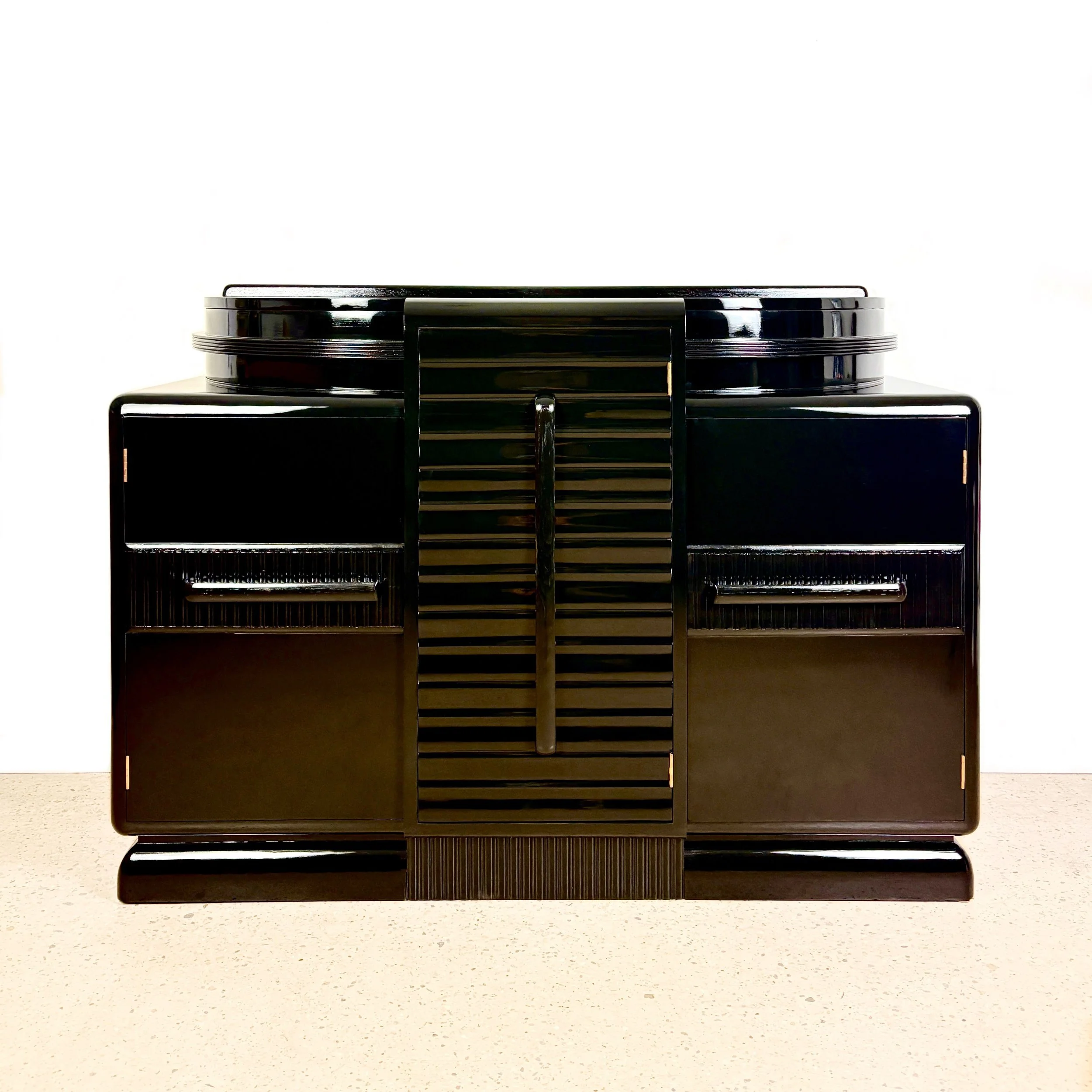    Project No. EP113 - ‘Rio’    High gloss black mirror-effect Art Deco sideboard in ‘streamline-moderne’ style with orange interior colour pop. 