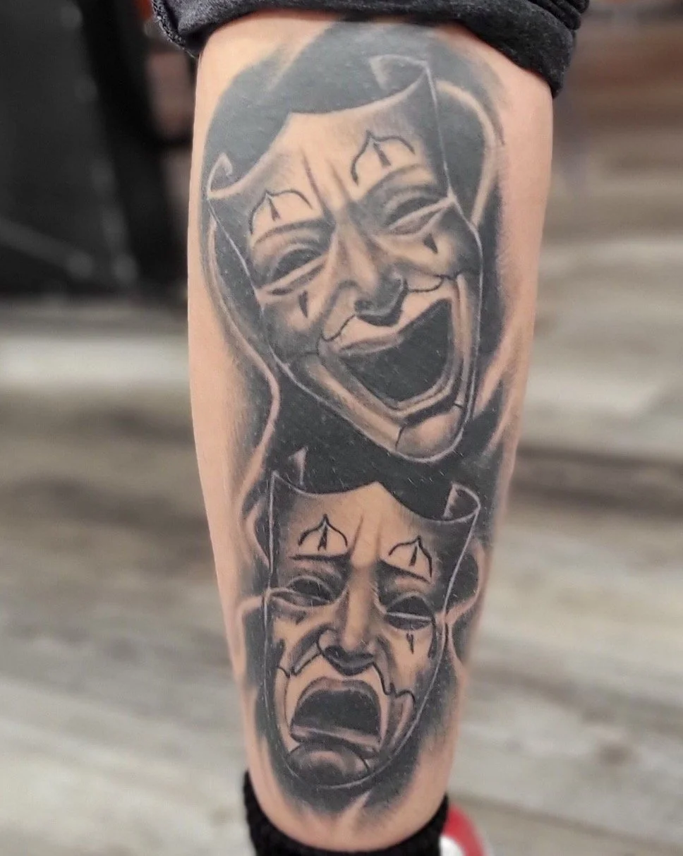 Tattoo depicting two comic-style angry clown faces, one above the other, on a person's leg.