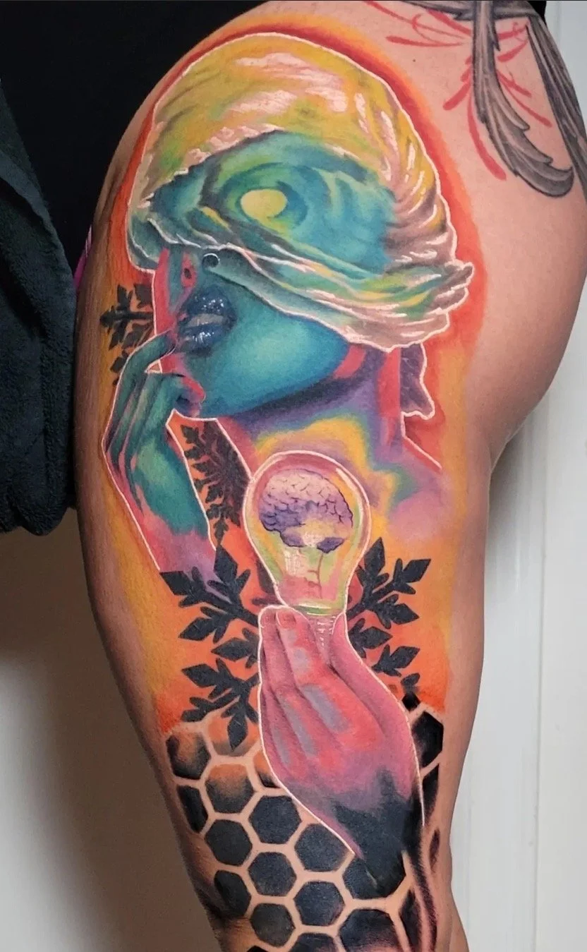 Full color tattoo of a woman head with an ocean wave, a light bulb with a brain inside, and black honeycomb and snowflake patterns.