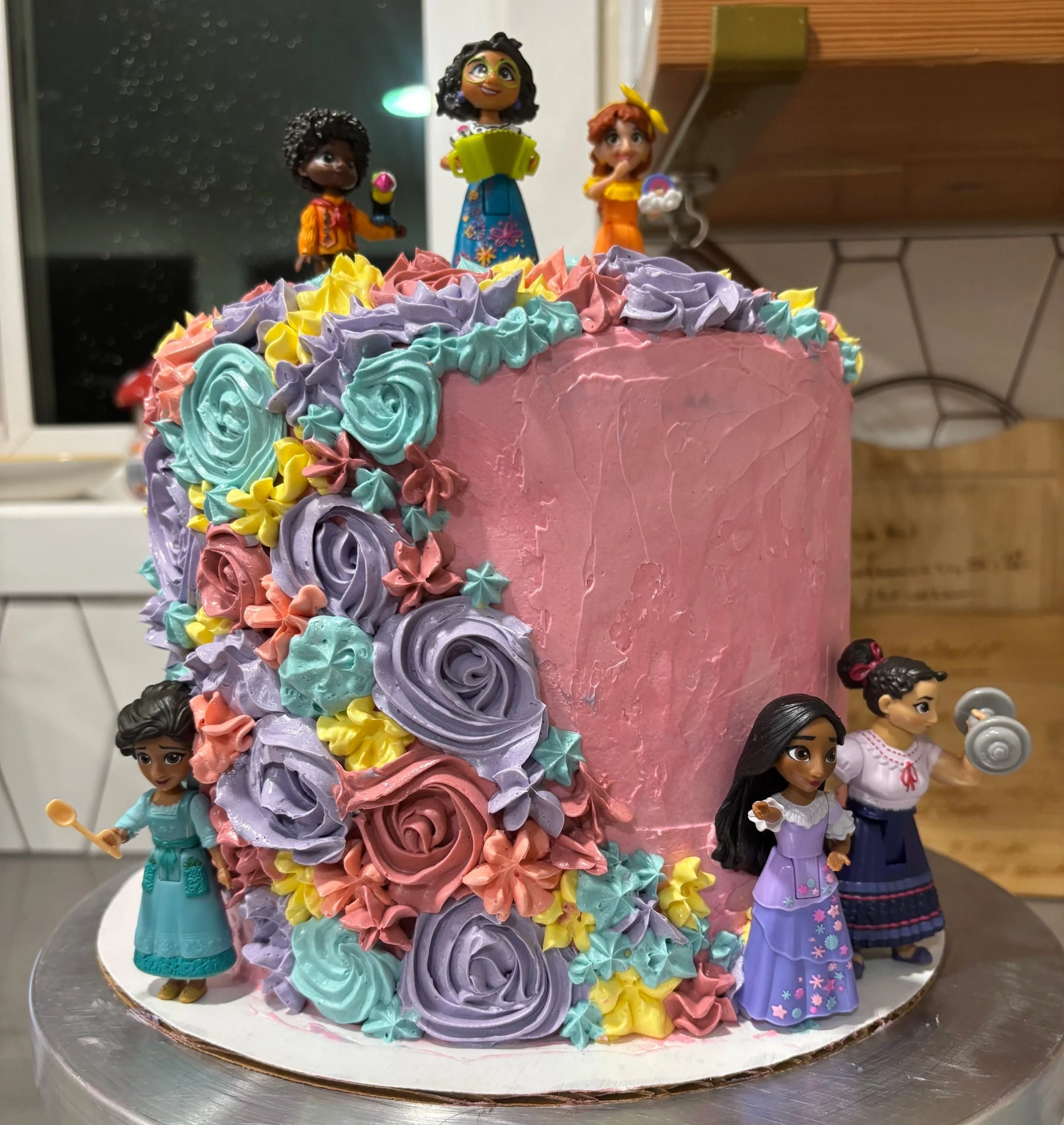  The “Encanto” themed birthday cake, complete with bright florals (thank you Americolor gel coloring) and figurines purchased by the birthday girl’s mom! 