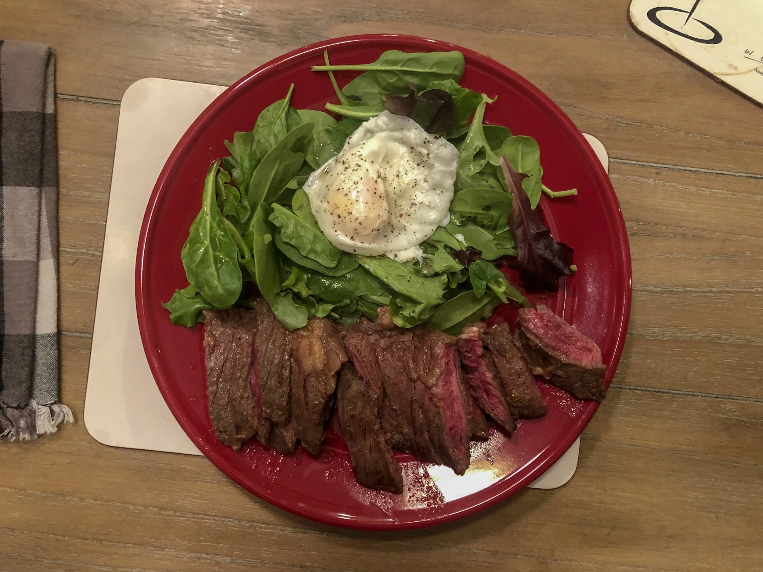 Mmmm… steak with a poached egg on a bed of greens