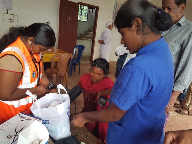 Emergency Providers tending to a patient in one of the relief camps.