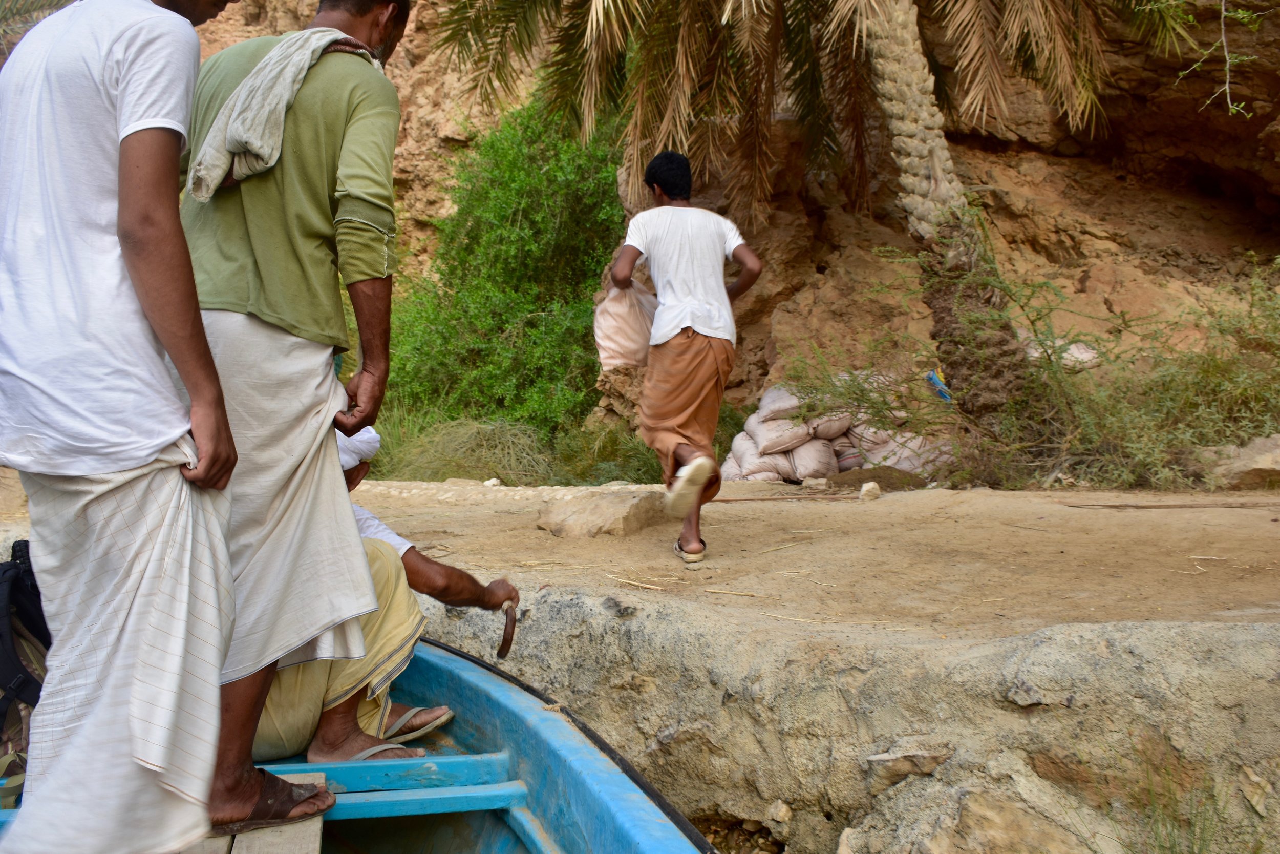  Men working up the canyon who accompanied us on the boat ride to get to the starting point for the Wadi Shab hike 