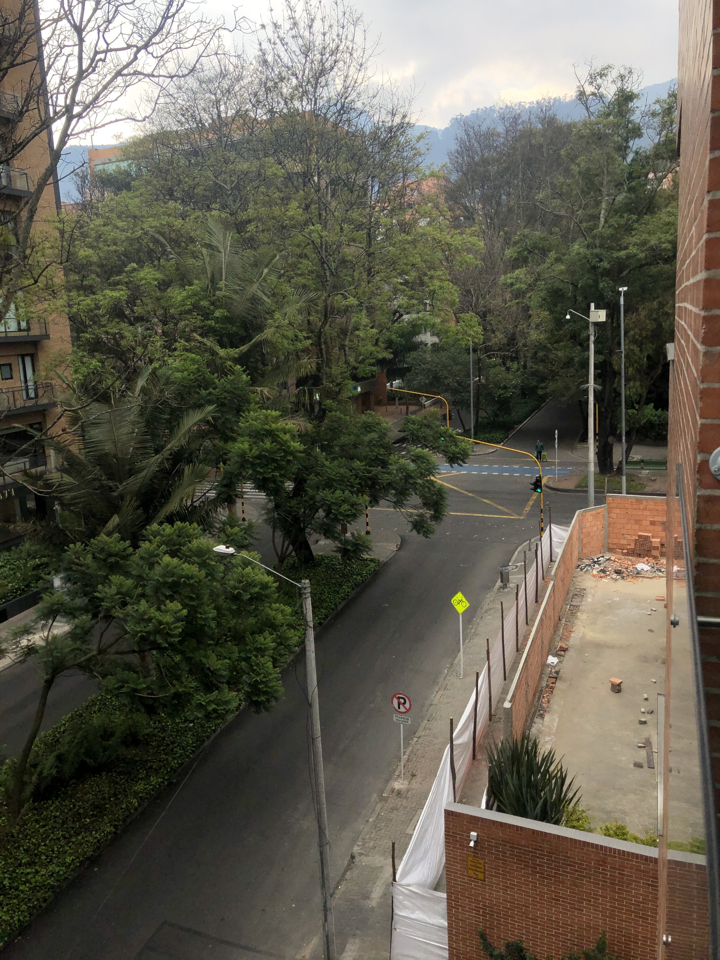  This view is normally packed with cars blocking the intersection, honking, and speeding around while pedestrians try to carefully make their way through the mess. 